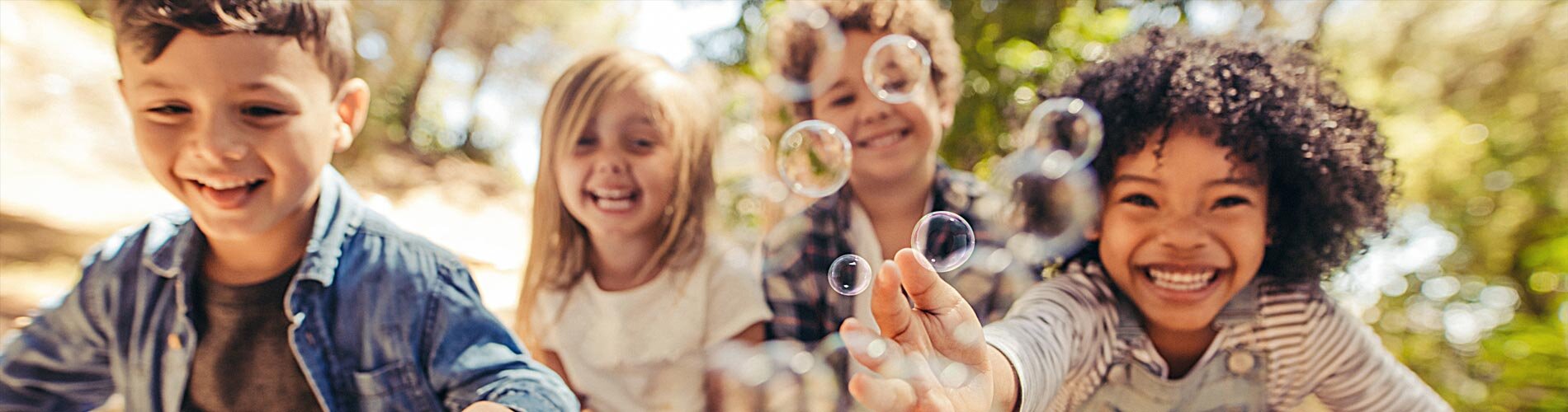 Four children blowing bubbles.