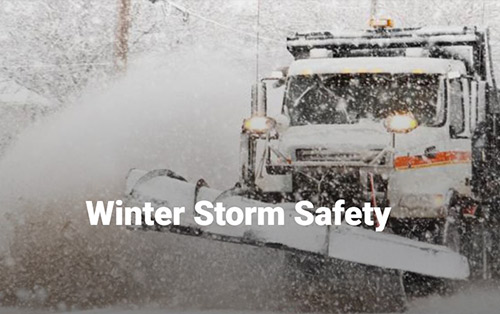 Snow plow removing snow from street.